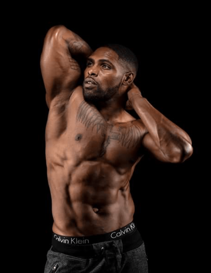 musclemenmalestrippers-thirtysix a man holding his hands up